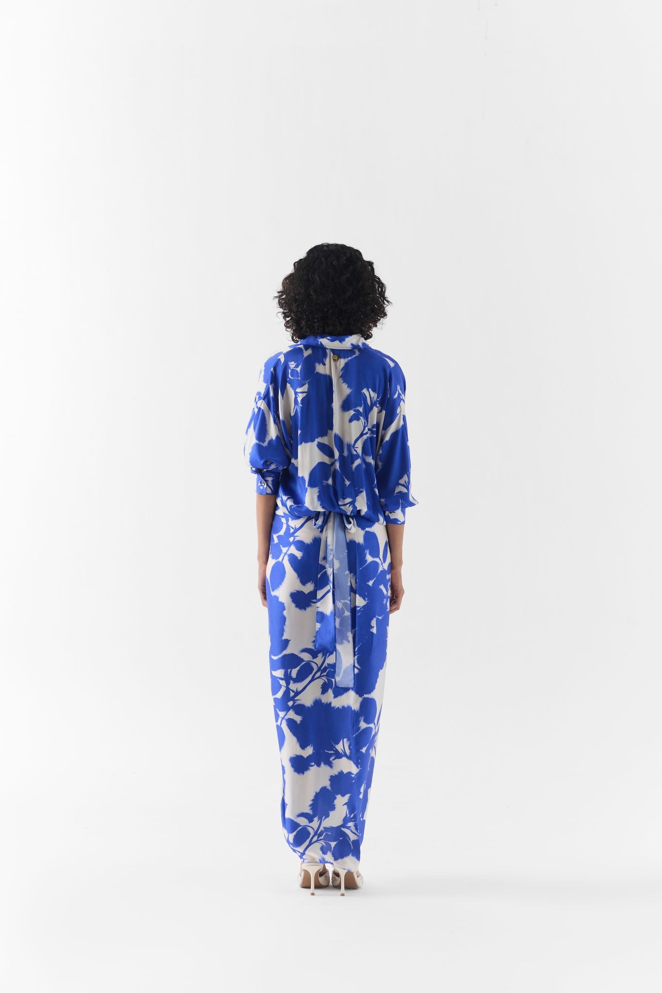 Side view of the Blue Ink Draped Shirt Dress highlighting its fluid drape