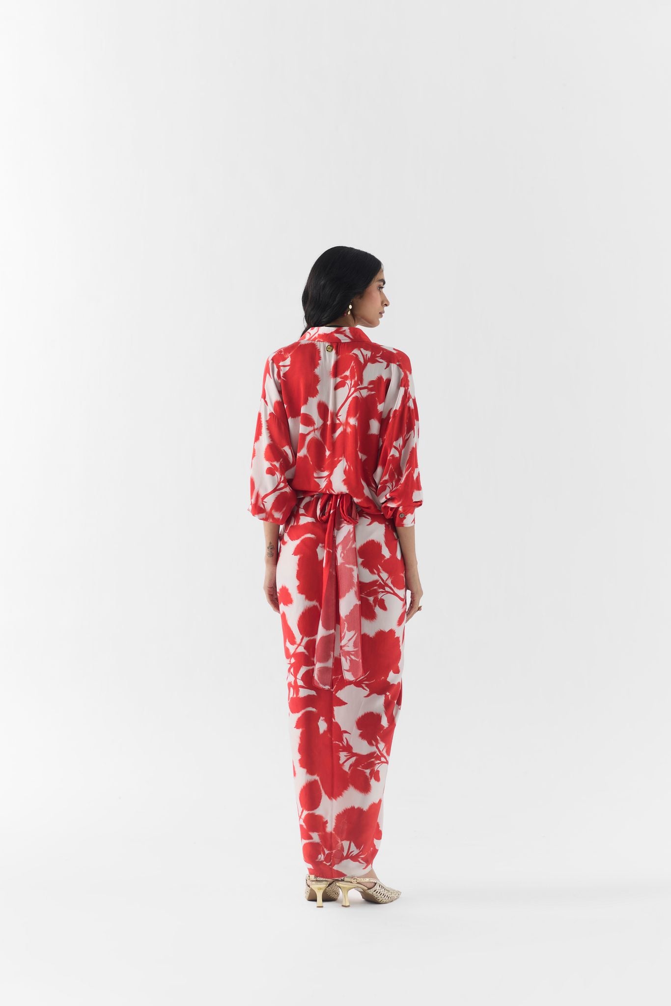 Close-up of red ink print fabric and collar detail on the draped shirt dress