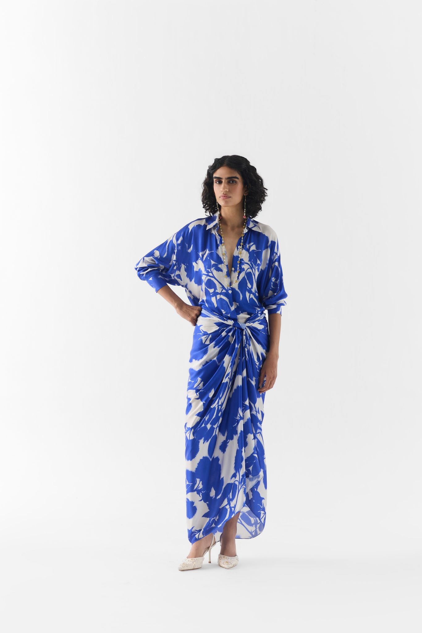 Close-up of blue ink print fabric and collar detail on the draped shirt dress