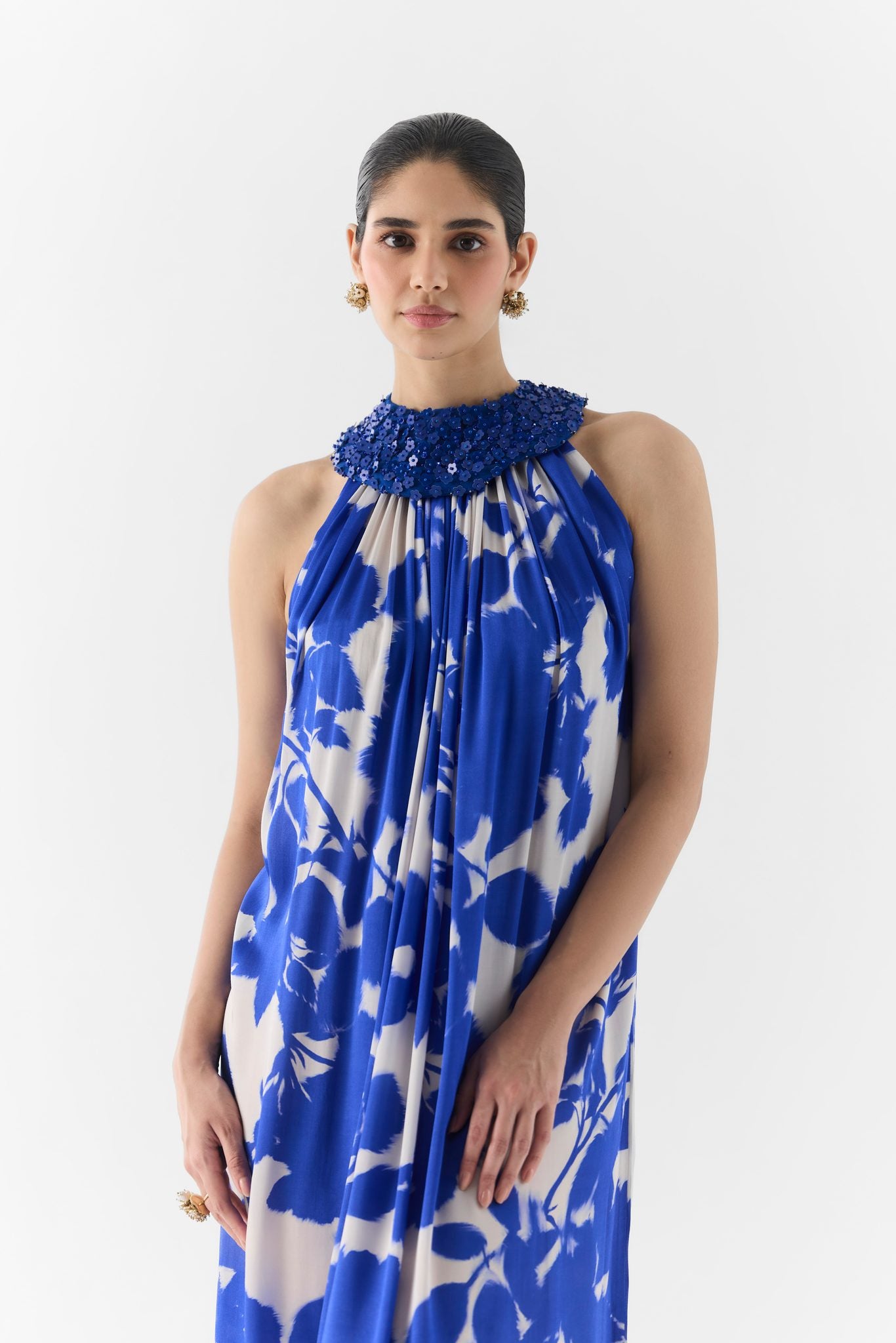 Side view of the Blue Ink Halter Dress showing collar and body-skimming fit