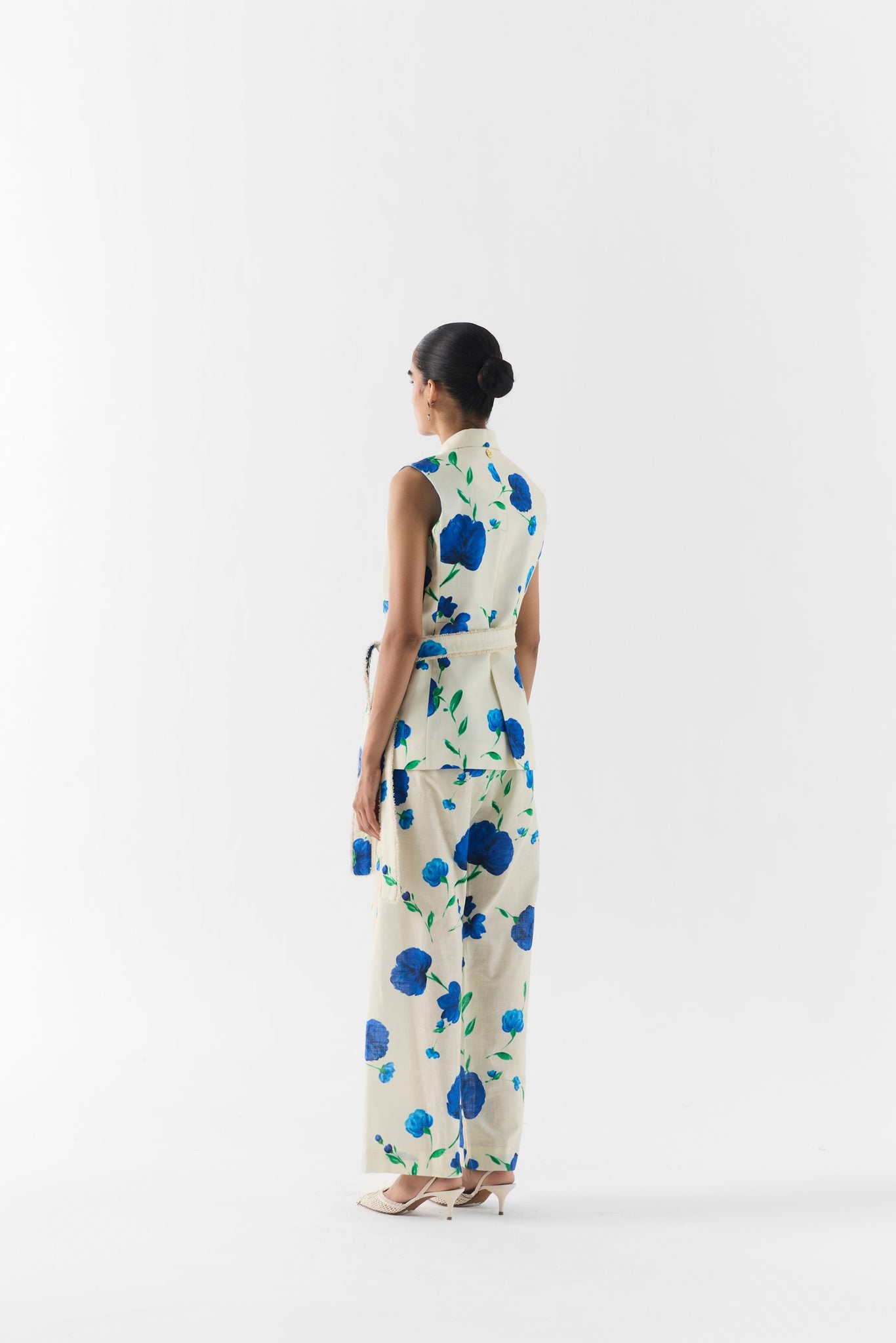 Detail of moss rose print and lapel finish on the sleeveless blazer