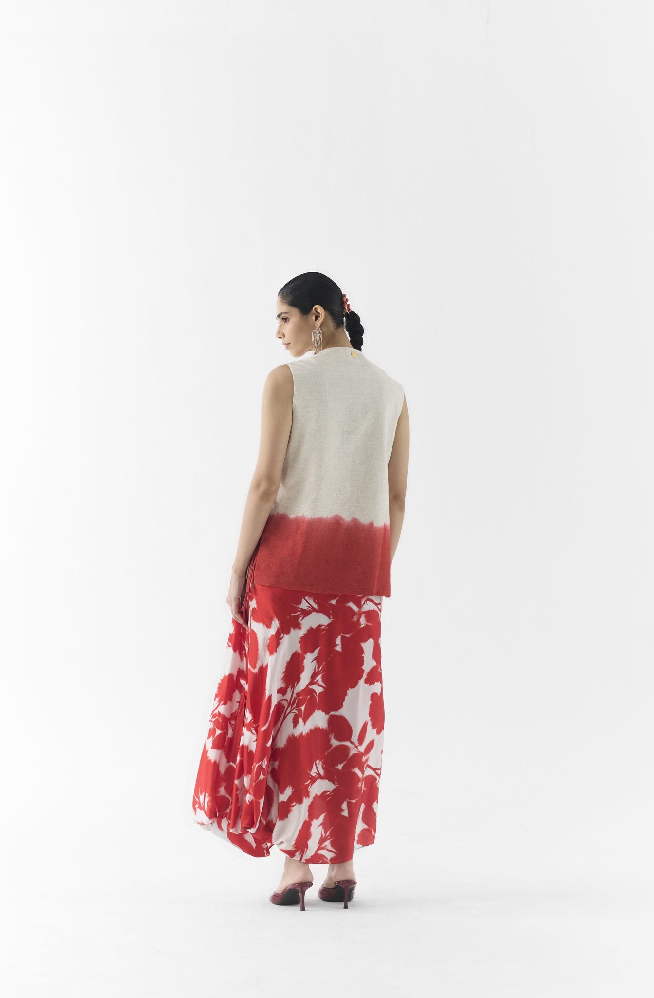 Close-up of red ink print fabric detail on Studiorigu vest and dhoti pants