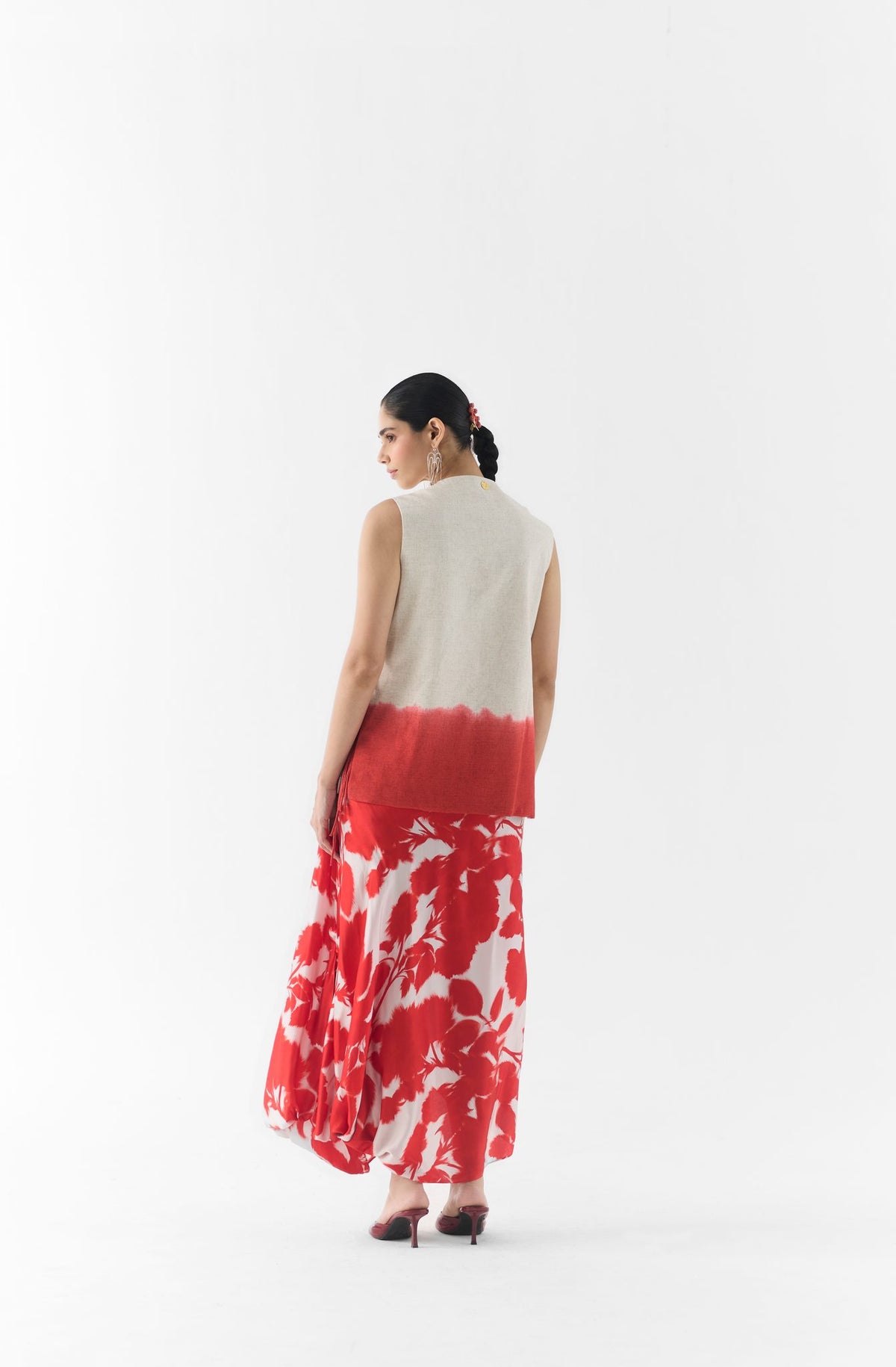 Close-up of red ink print fabric detail on Studiorigu vest and dhoti pants